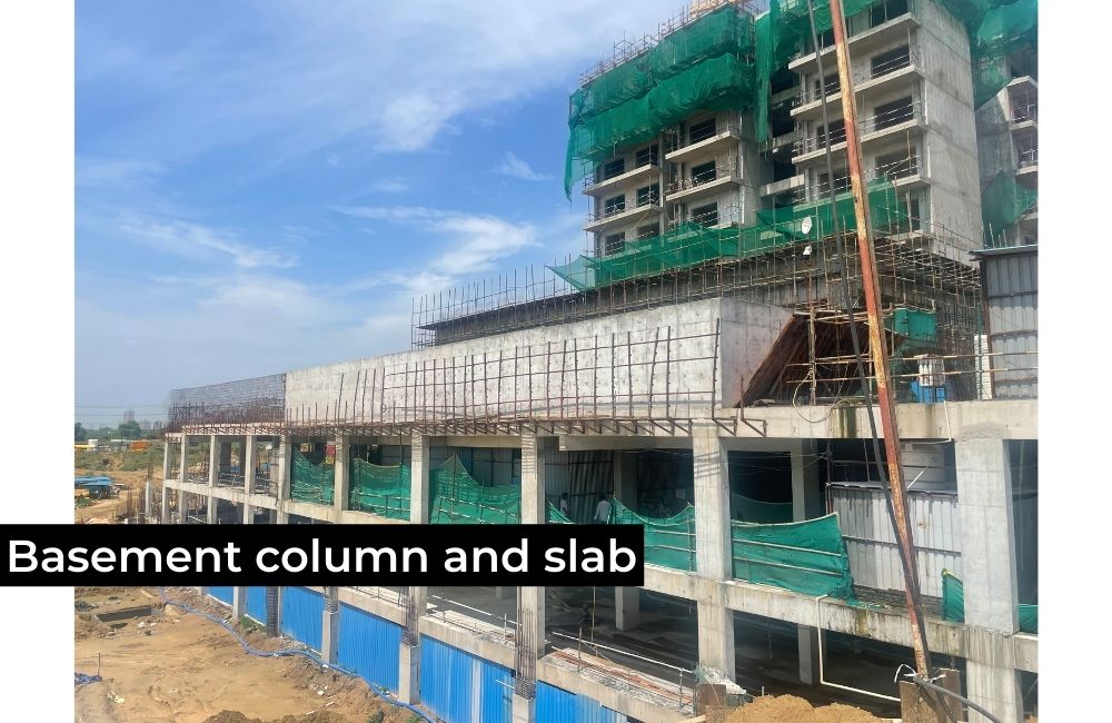 Crane lifting prefabricated facade panels for installation on the building exterior.