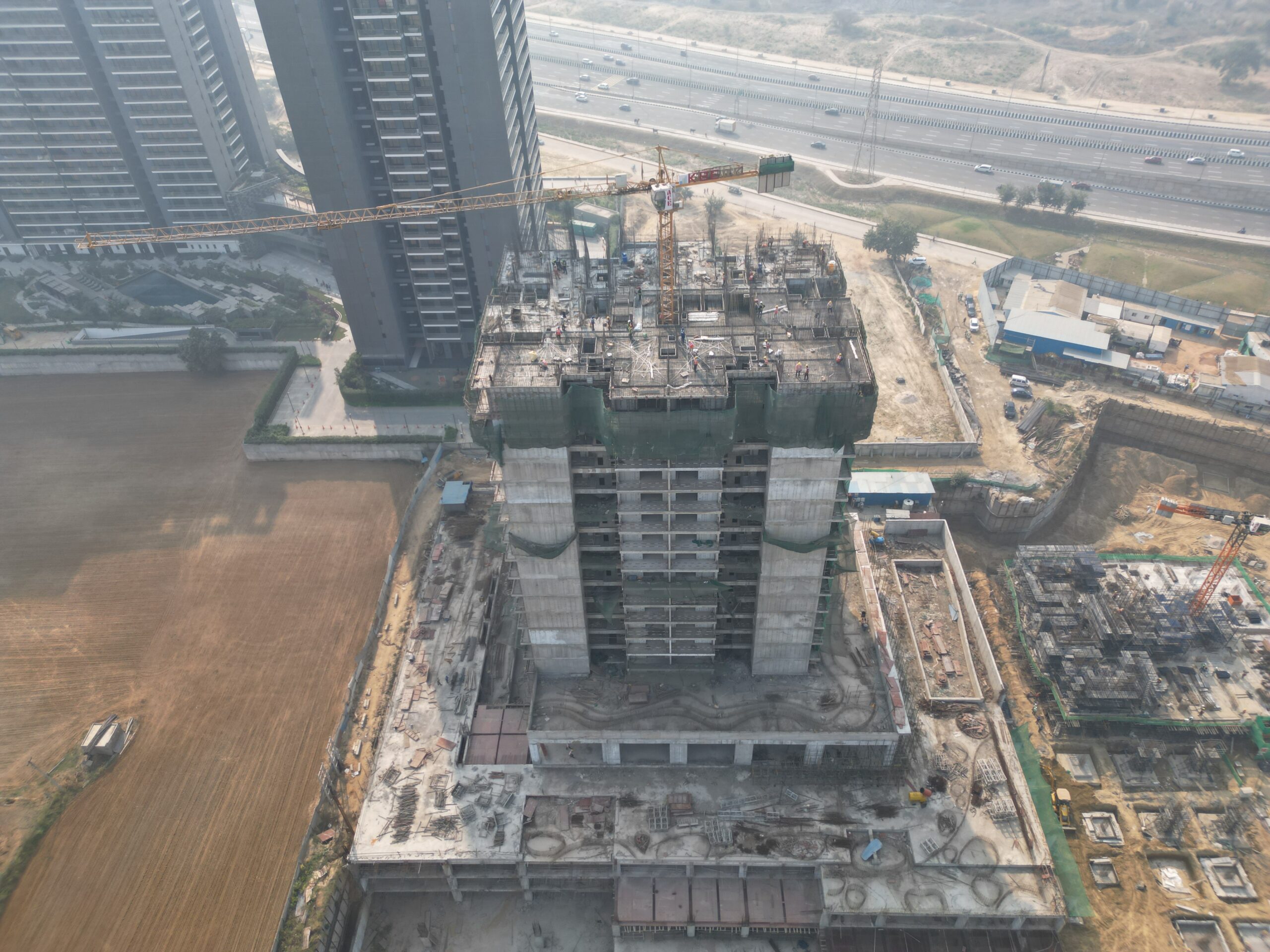 high-rise building under construction in an urban area.