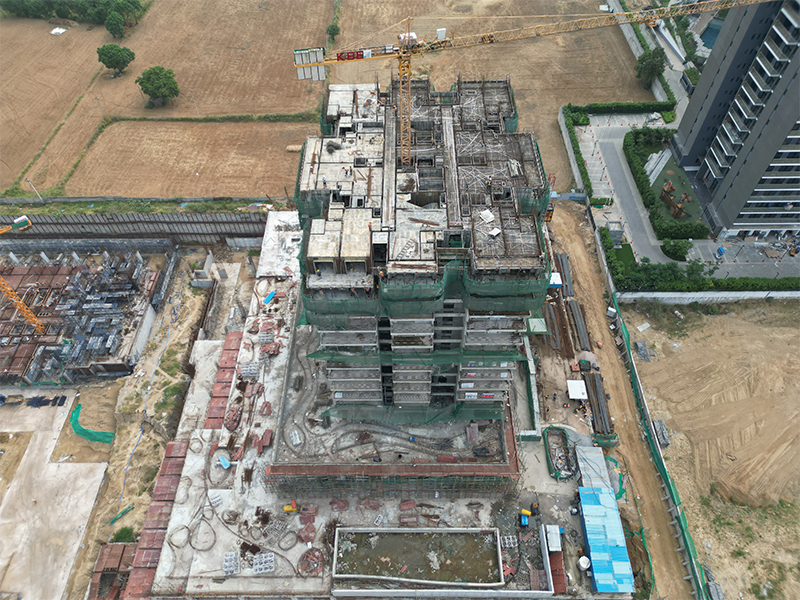 aerial view of an active construction site for a high-rise building.